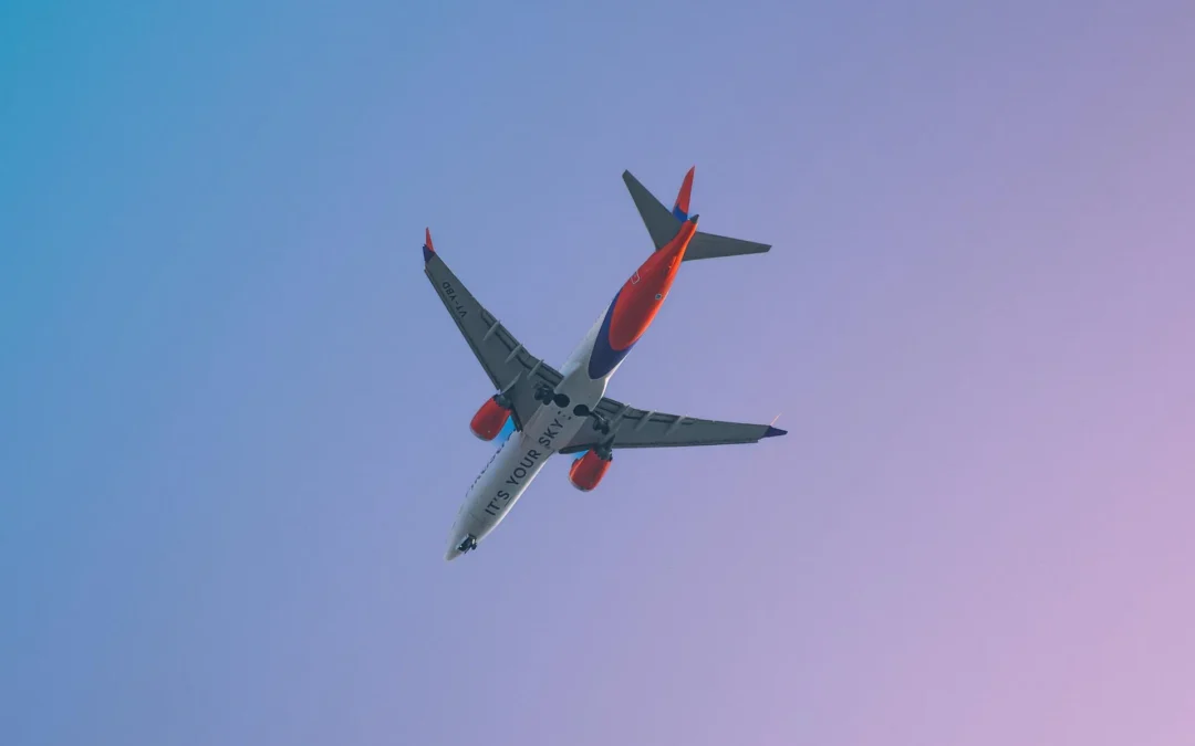 A Boeing 737 MAX in flight showing distinctive split-tip winglets.