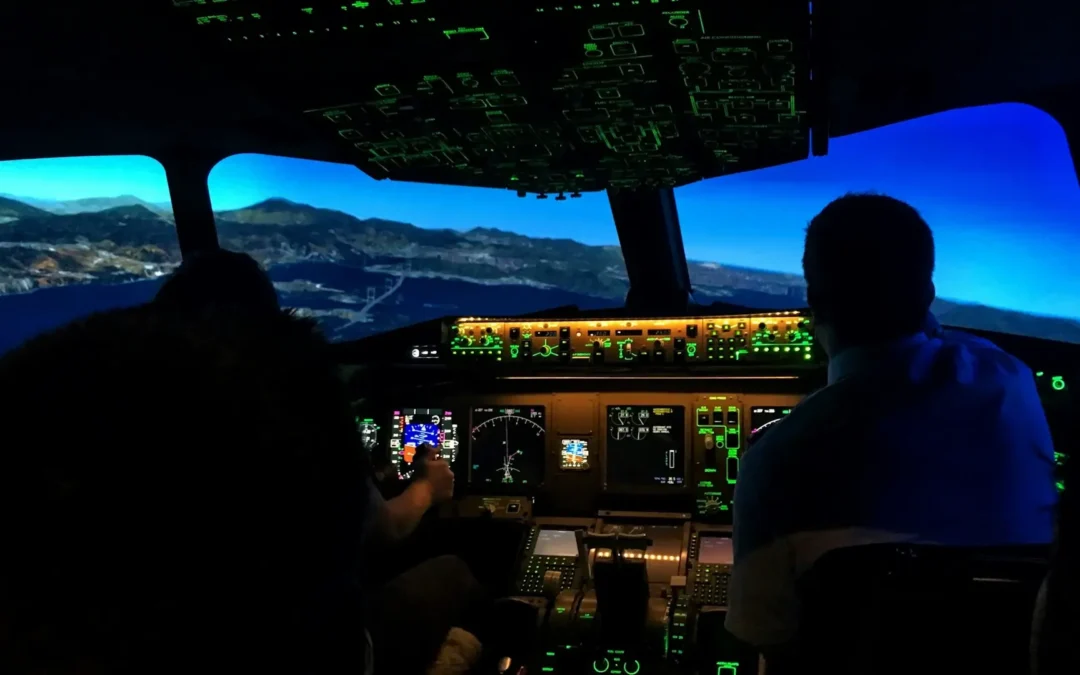 Pilots training in a cockpit simulator while reviewing ATP minimums