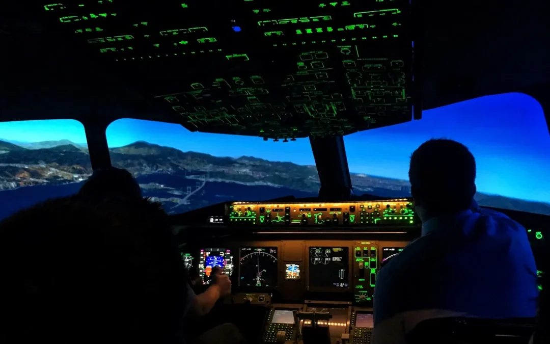 Pilots working inside a real cockpit simulator during professional training