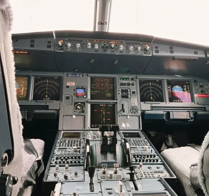 Modern aircraft cockpit with digital displays and controls, representing the 737 NG glass flight deck