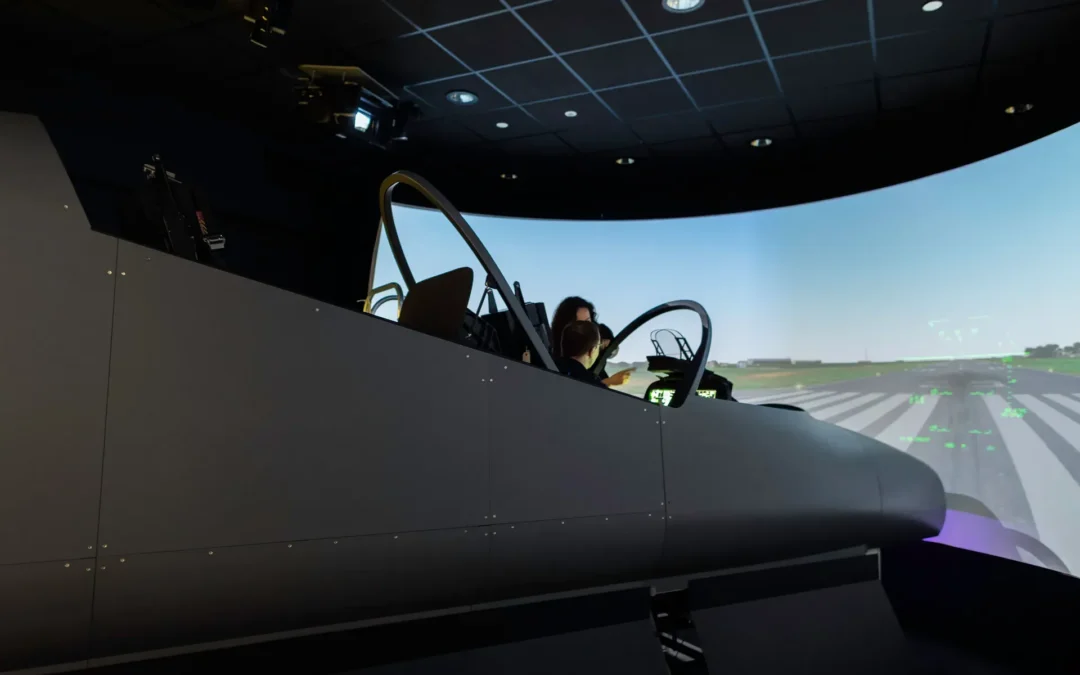 Flight simulator cockpit with control yokes and overhead panel used for FAA ATP CTP and airline training